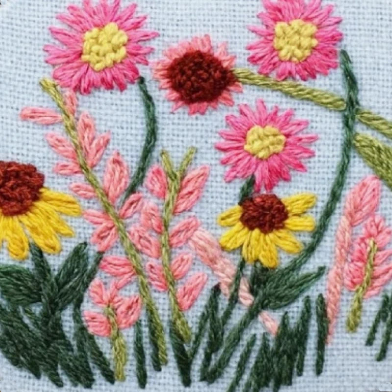 The lively pink, yellow, and coral flowers sway gracefully among lush green leaves, bringing a touch of nature’s poetry into your daily routine.