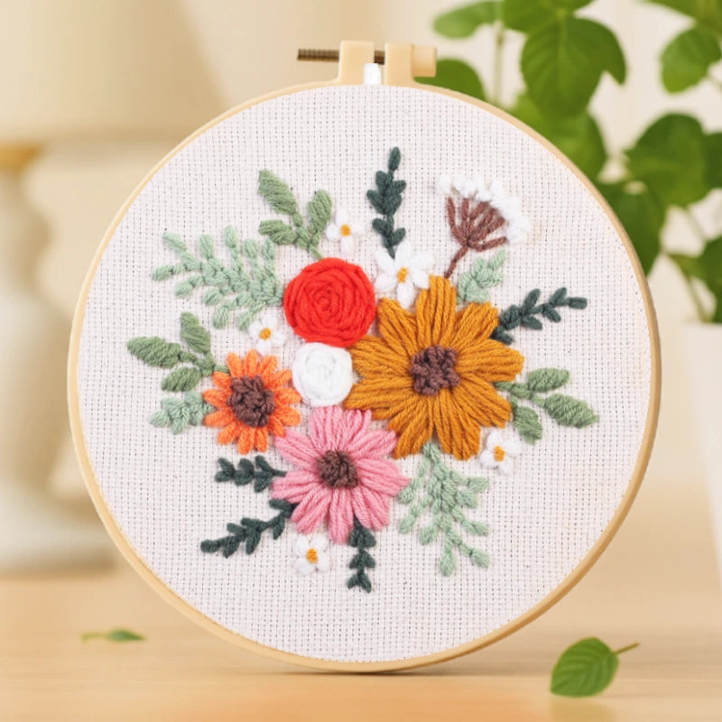 A lively mix of colorful blossoms, featuring warm orange, pink, and golden tones surrounded by soft green leaves. This vibrant floral arrangement symbolizes joy, creativity, and love. With its balanced composition and easy stitching, it’s perfect for brightening up your living space.