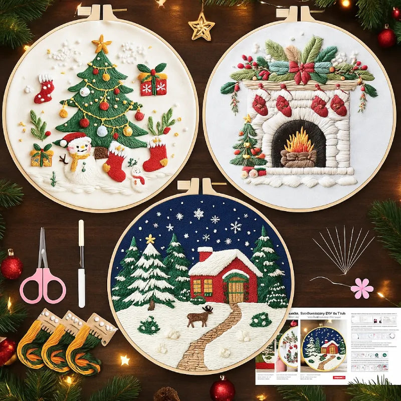 Three Christmas-themed embroidery hoops on a wooden surface with tools and decorations.