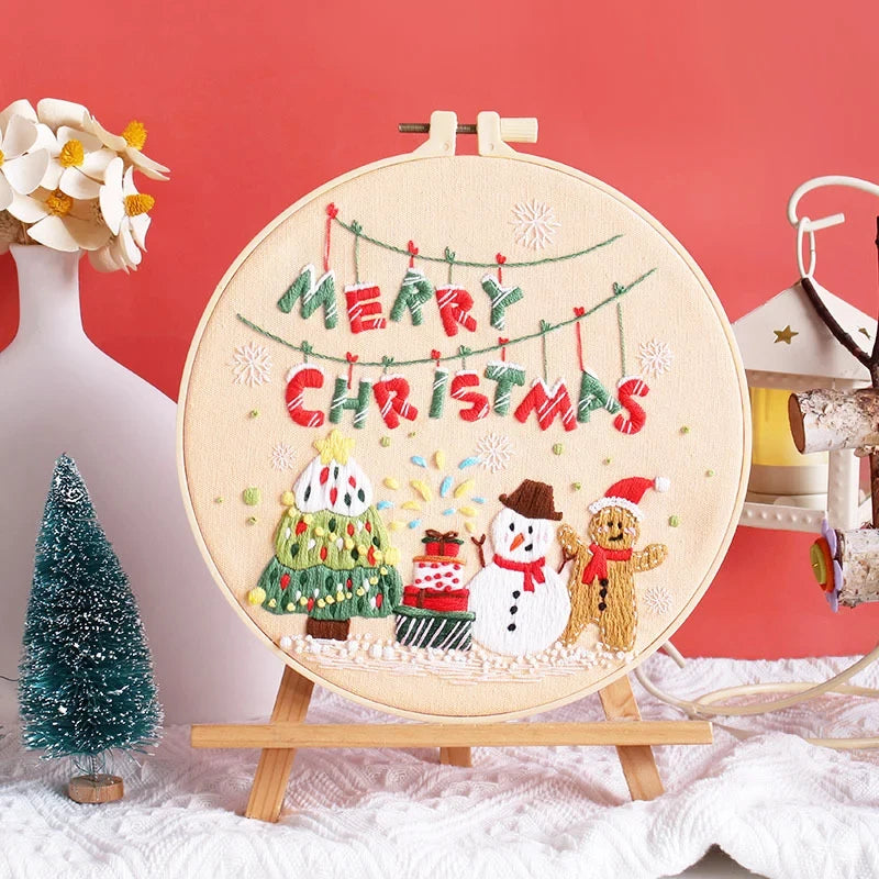 Set on a soft beige background, this cheerful embroidery captures a joyful Christmas party scene — a glowing tree, happy snowman, playful gingerbread man, and sparkling snowflakes all come together to celebrate the festive spirit. Perfect for Christmas décor or as a handmade gift to bring warmth and joy to your home.