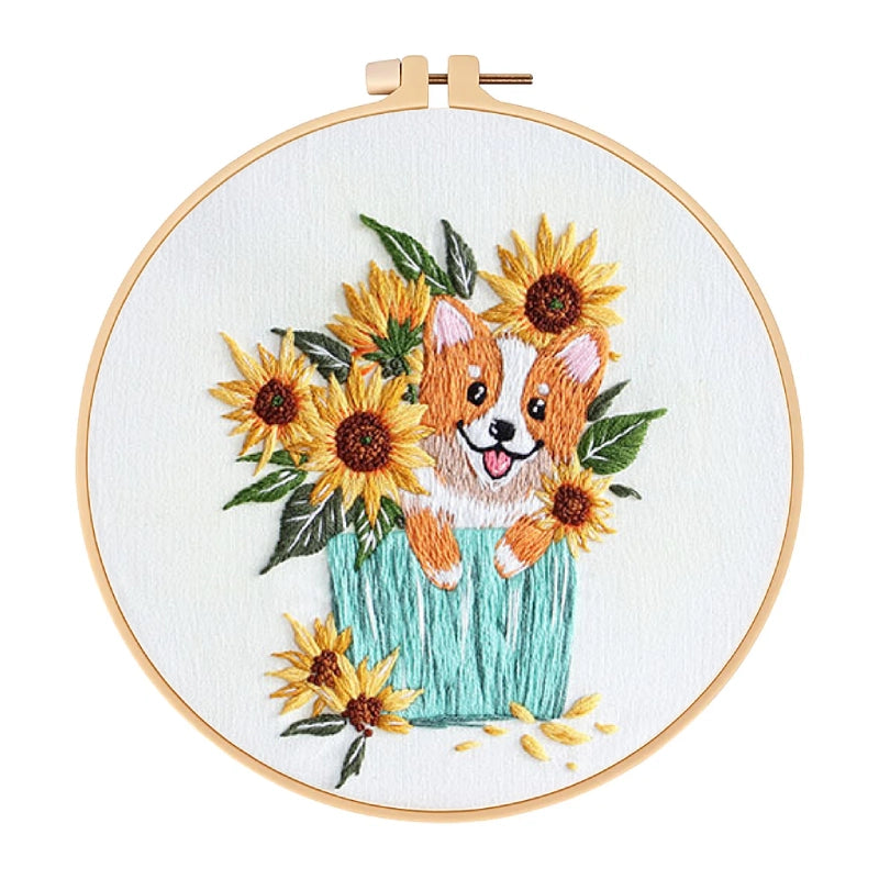 Embroidery hoop with a dog and sunflower design on a white background