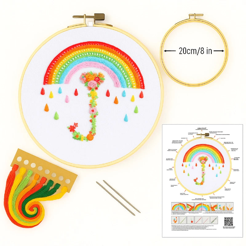 Embroidery kit with rainbow design, hoop, threads, and instructions on a white background